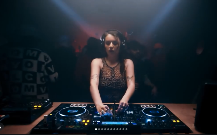 Female DJ / producer mixing tracks on decks
